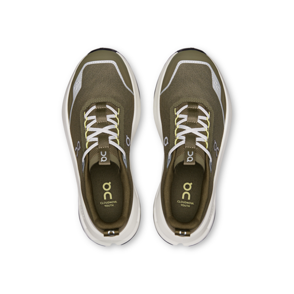 Pair of olive green running shoes with white soles on a white background