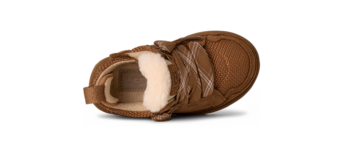 Brown children's shoe with white fur lining on a white background