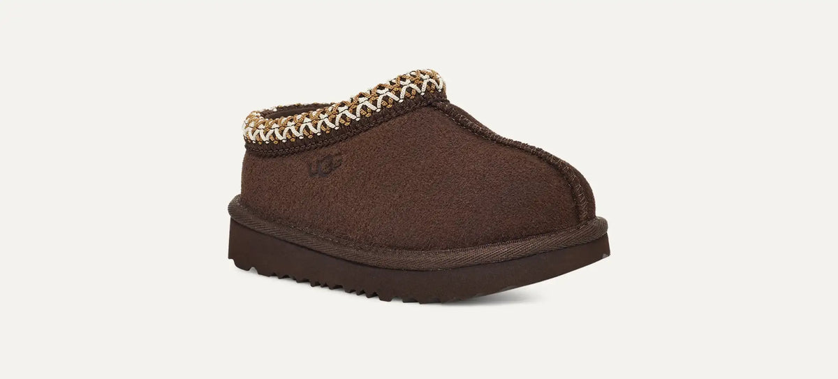 Brown slipper with leopard print trim on a white background