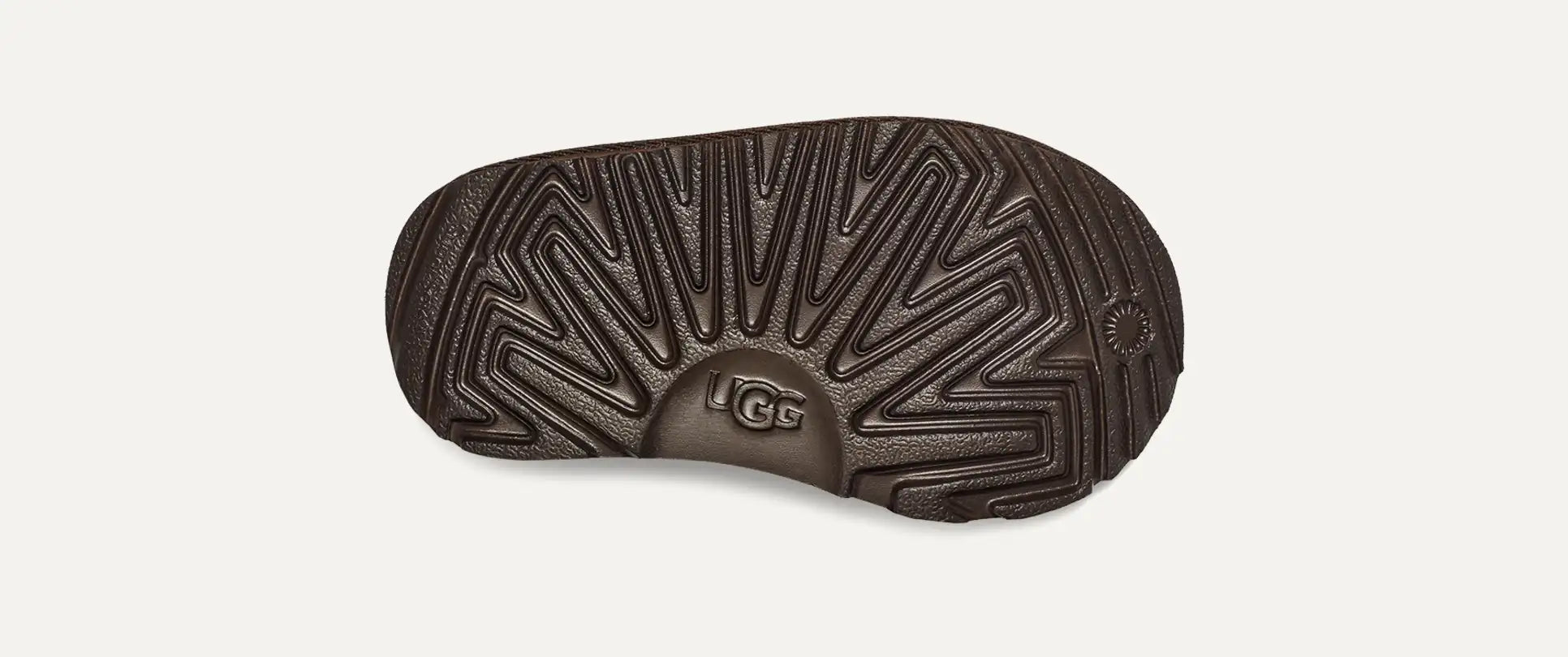 Dark brown UGG shoe sole on a light gray background