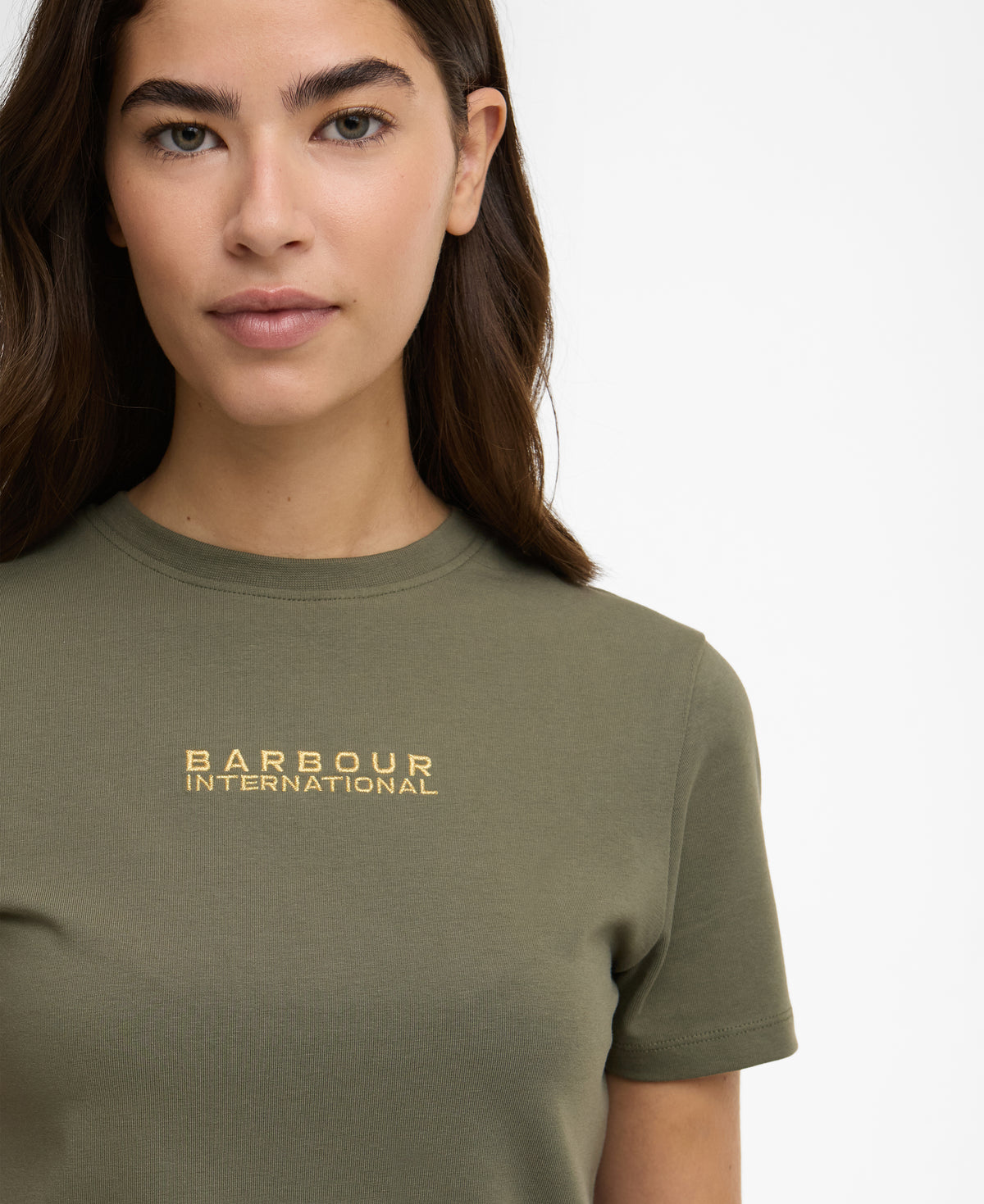 Person wearing a green t-shirt with 'Barbour International' logo on a white background