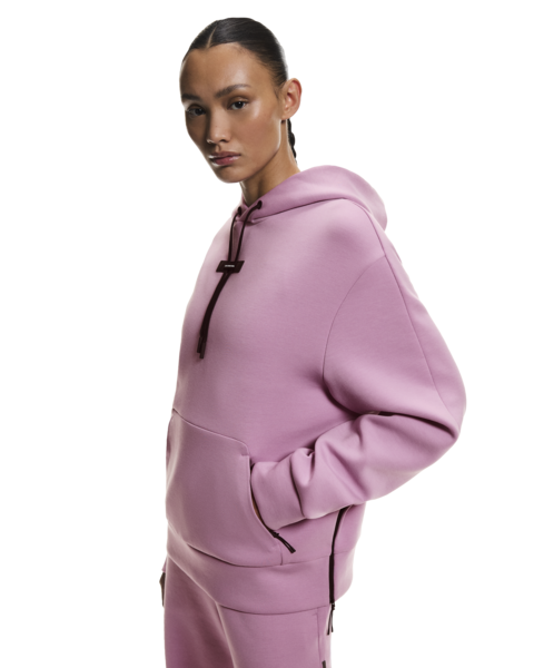 Person wearing a pink hoodie on a white background