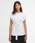 Woman wearing a white top with a belt on a plain background