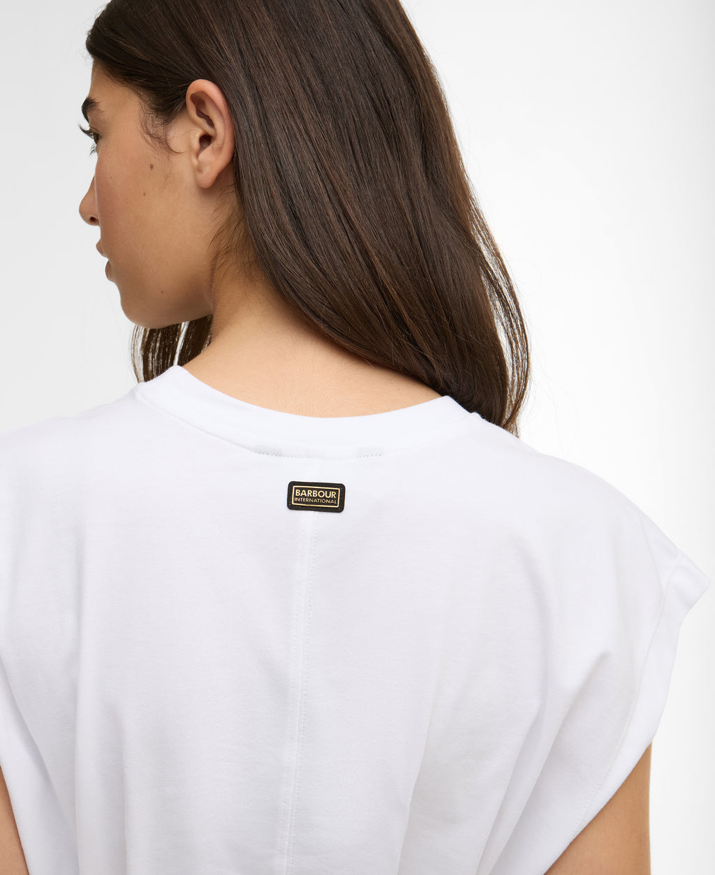 White t-shirt with a brand logo on the back worn by a person against a white background
