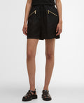 Black shorts with gold zippers worn by a person on a white background