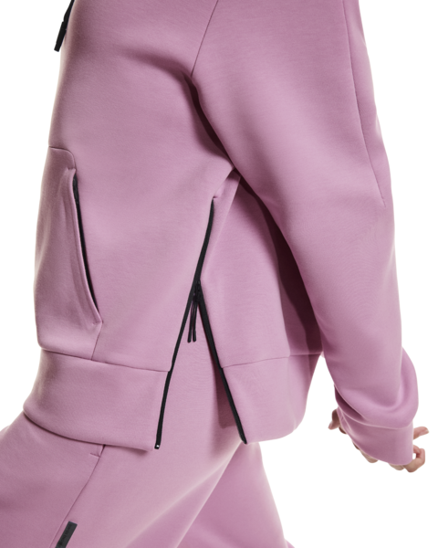 Close-up of a pink outfit with black zippers on a white background