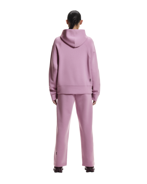Person wearing a pink tracksuit on a white background