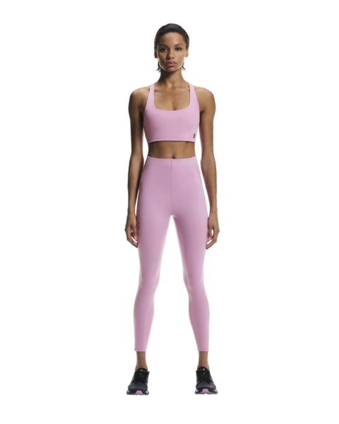 Woman wearing a pink athletic outfit on a white background