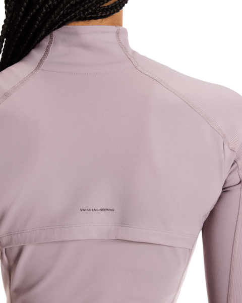 Close-up of a light purple athletic top with 'Swiss Engineering' text on a white background