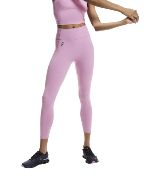 Person wearing pink athletic leggings and top on a white background