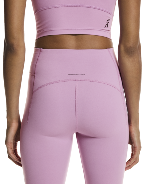 Person wearing a pink athletic outfit with a brand logo on a white background