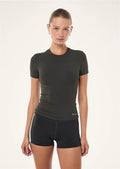 Woman wearing a black athletic outfit on a white background