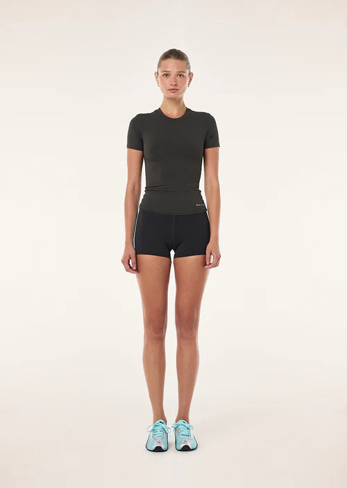 Person wearing a black athletic outfit on a white background