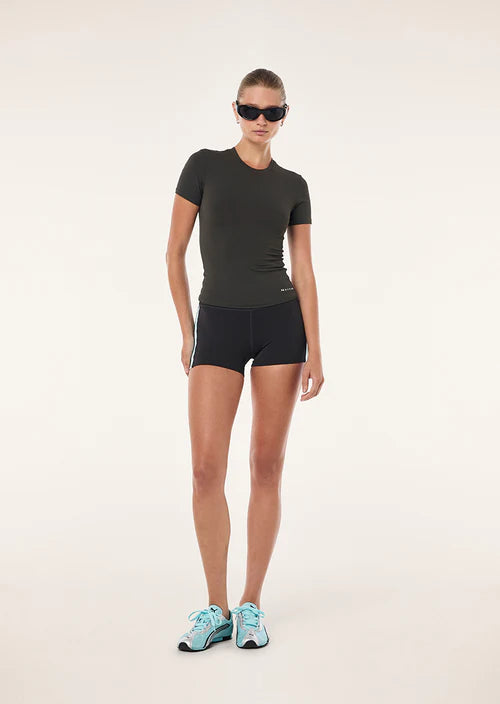 Person wearing a black athletic outfit with sunglasses on a white background