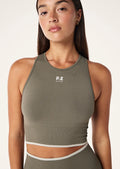 Perosn wearing a activewear Women's P.E Nation Khaki Restore Seamless Tank top with a white background