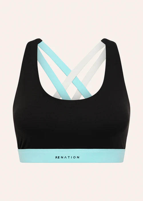 Black sports bra with a colorful criss-cross design on a beige background