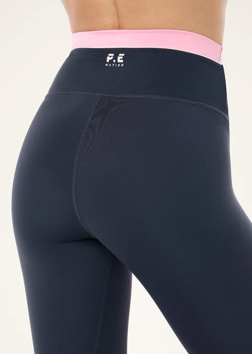 blue leggings with a pink waistabnd with a P.E nation visible logo on a model
