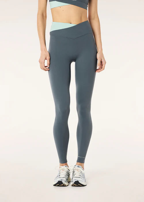 Person wearing gray leggings on a plain background