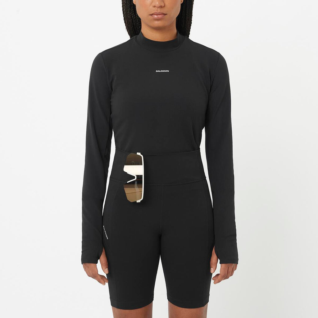 Black long sleeve activewear top with a pocket on a white background