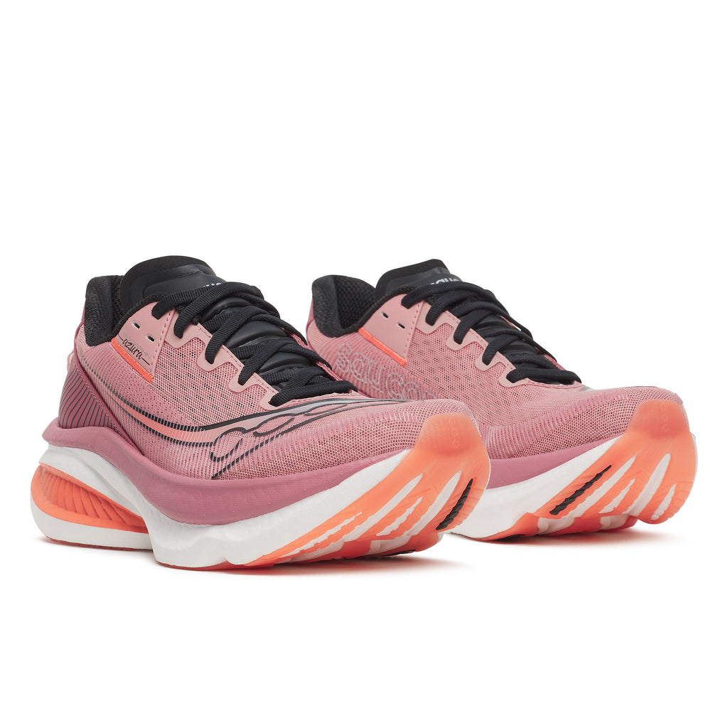 Pink running shoes with black and orange accents on a white background