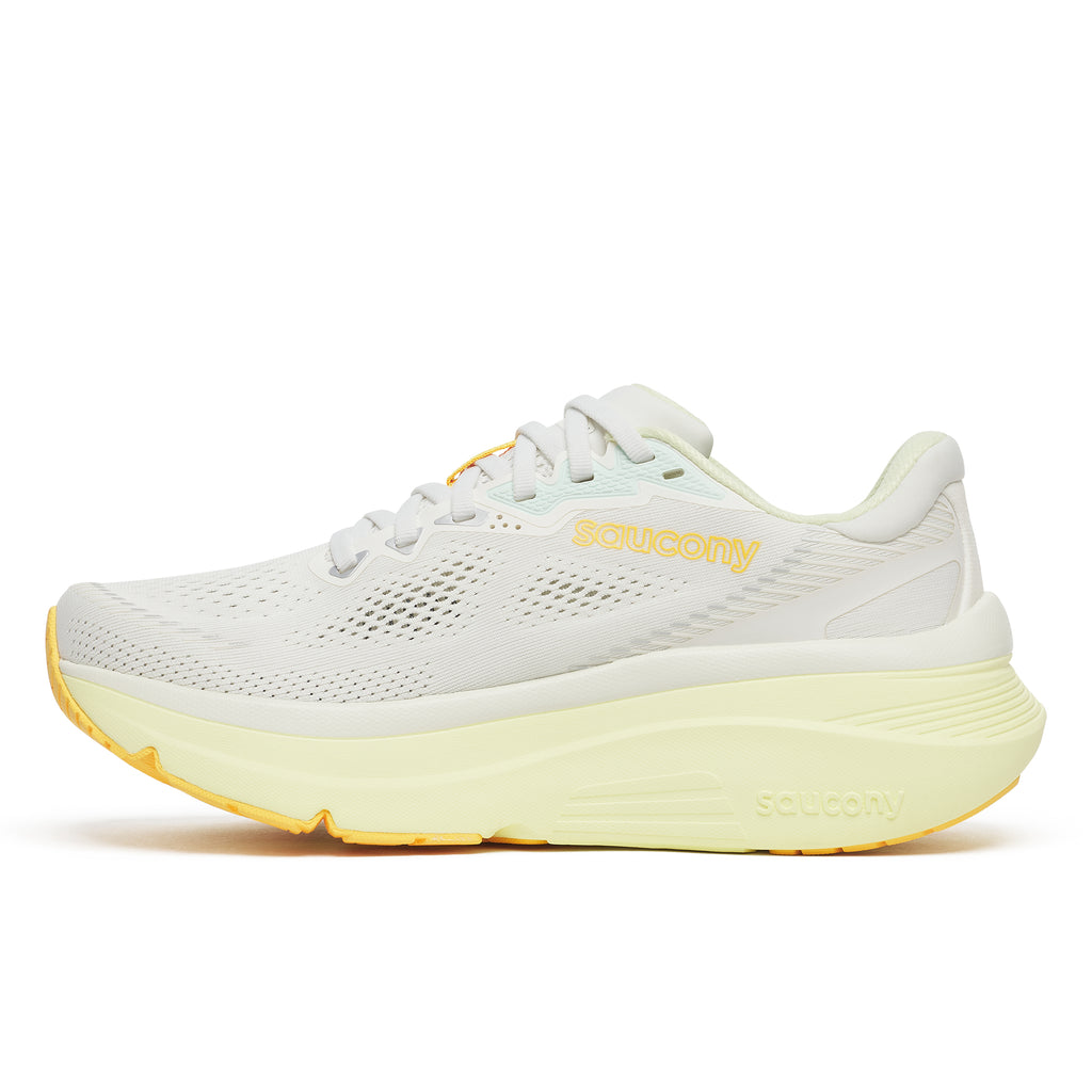 White running shoe with yellow sole on a white background