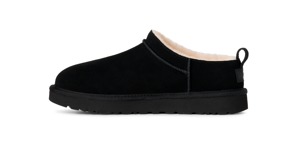 Black slip-on shoe with white interior on a white background