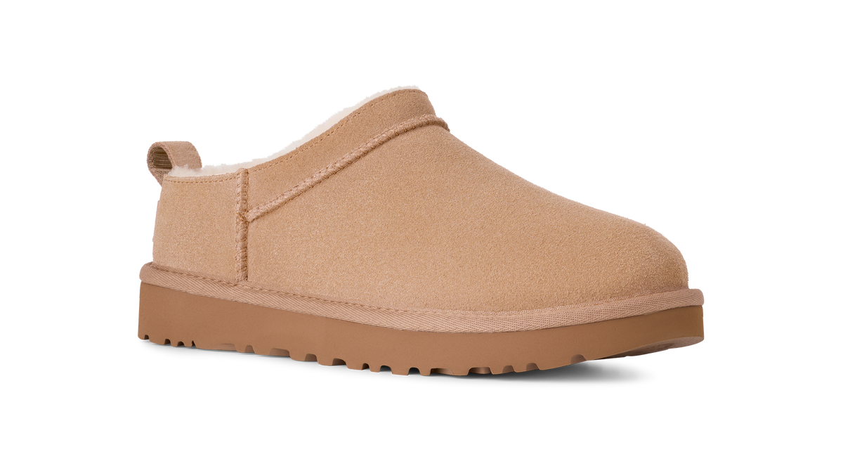 Beige slip-on shoe with a white interior on a white background