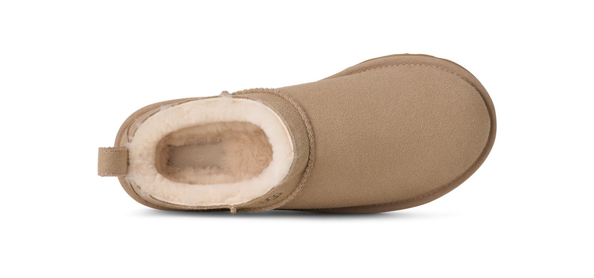Tan boot with white fur lining on a white background