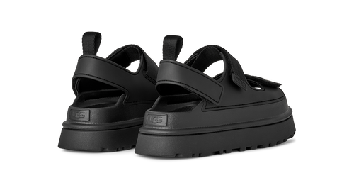 Black UGG sandals with thick soles on a white background
