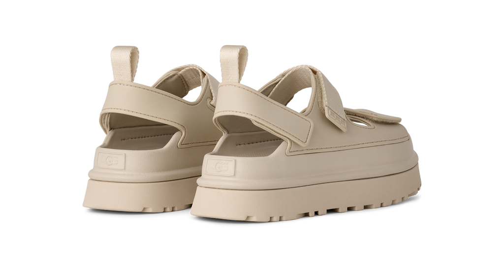 Beige platform UGG sandals on a white background