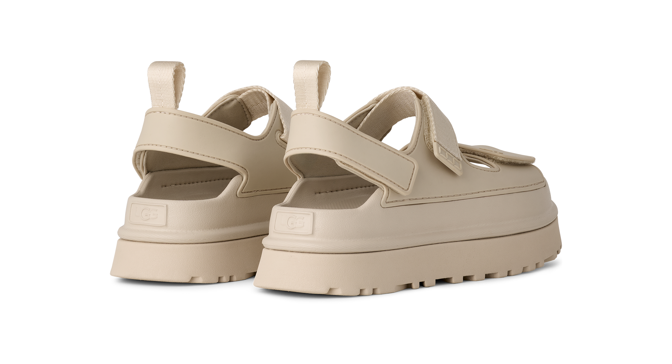 Beige platform UGG sandals on a white background