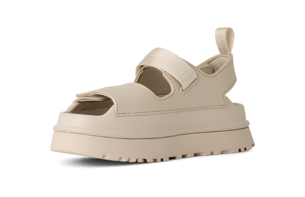 Beige UGG sandal with a thick sole on a white background
