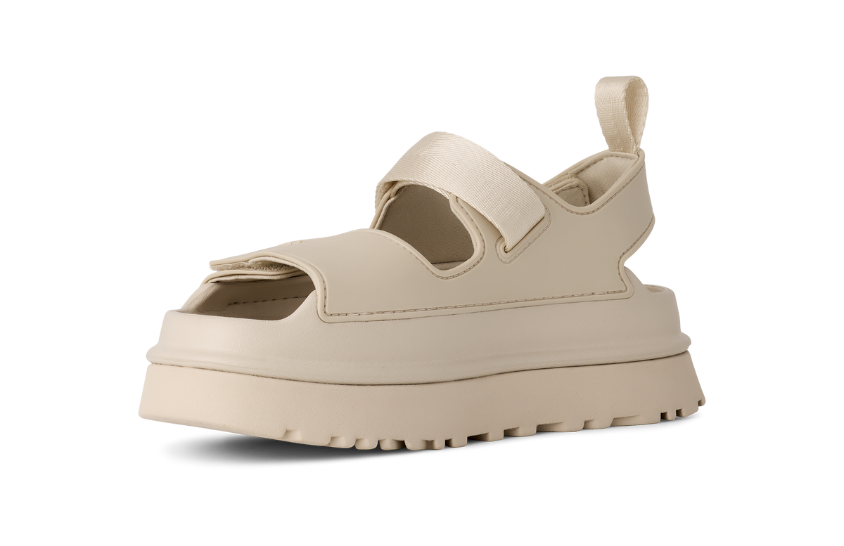 Beige UGG sandal with a thick sole on a white background