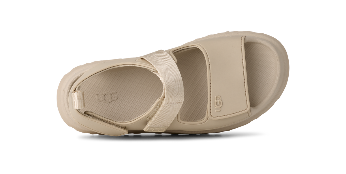 Beige sandal with UGG logo on a white background