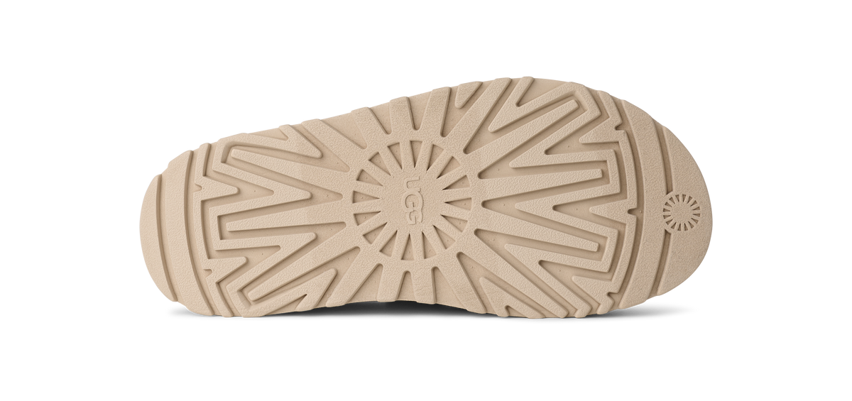 Close-up of a beige sole with a textured pattern on a white background