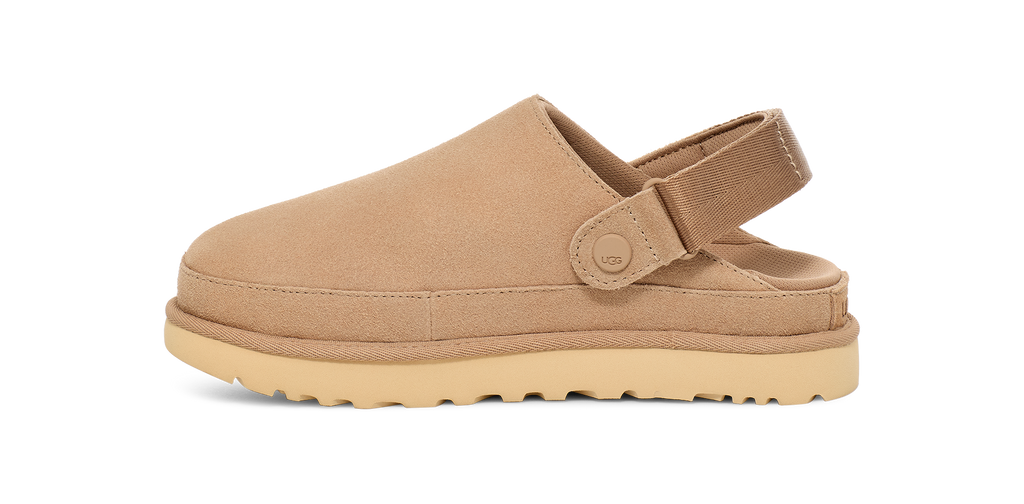 Tan clog shoe with a strap on a white background