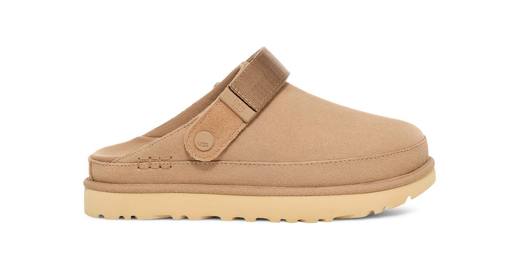 Tan clog shoe with a strap on a white background