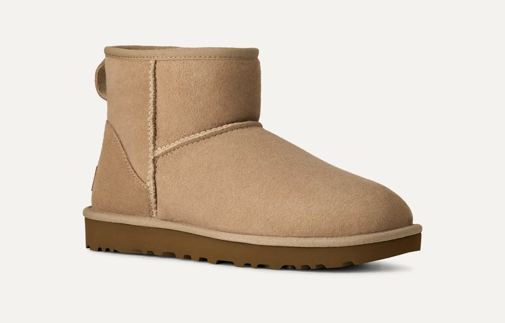 Sand coloured UGG suede boot with brown sole on a white background