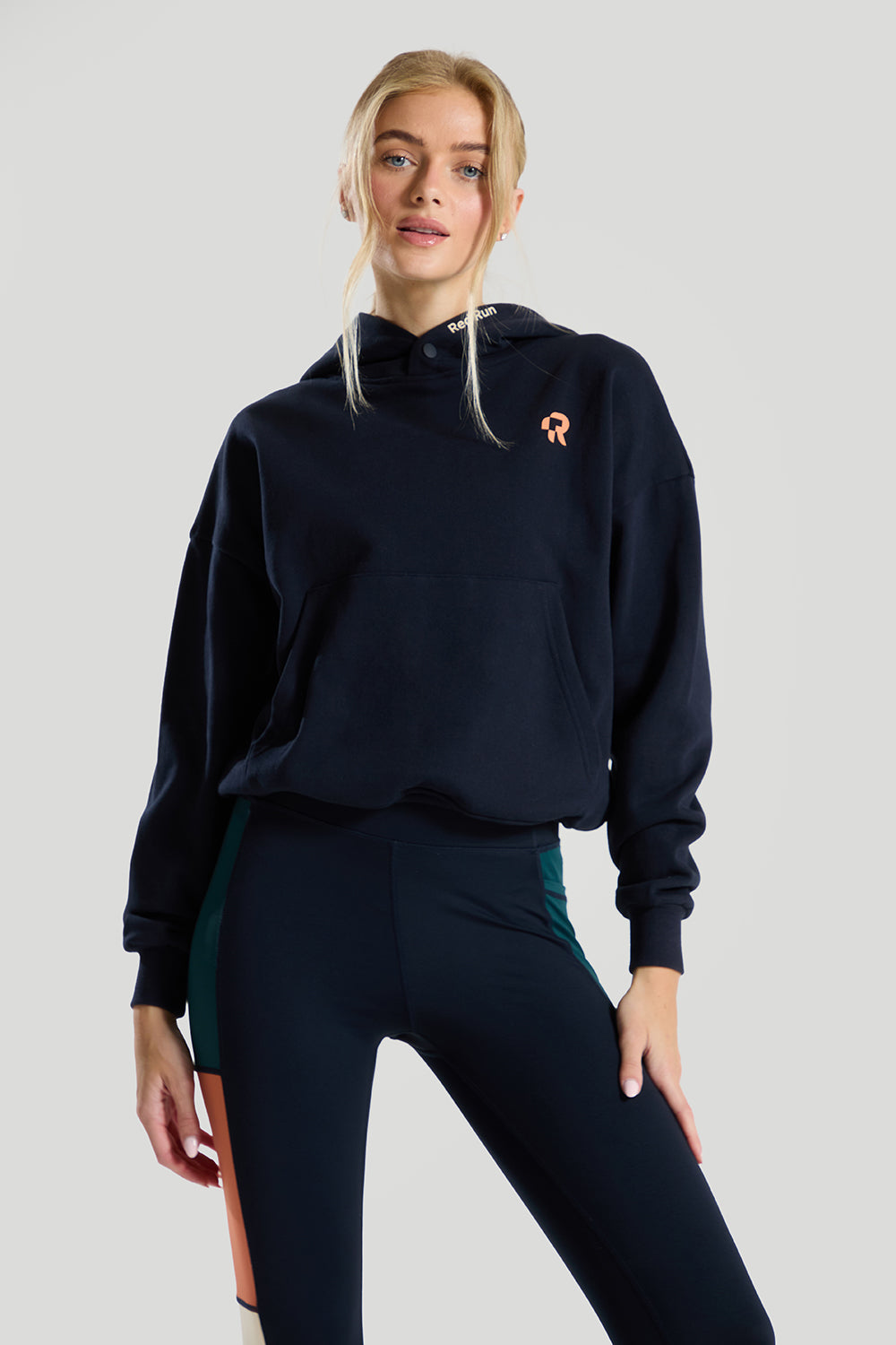 navy blue hoodie by red run on a grey background