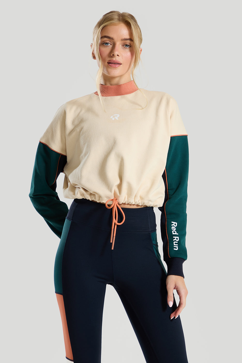 female model wearing a cream & green red run sweater 