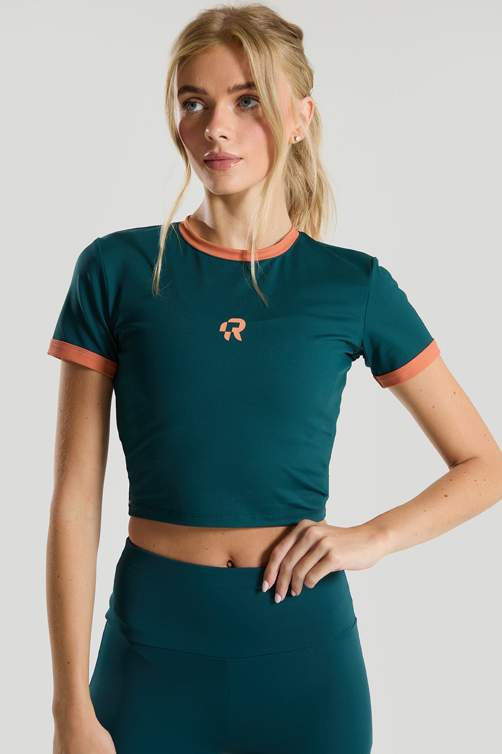 female model wearing a green crop short sleeve t-shirt