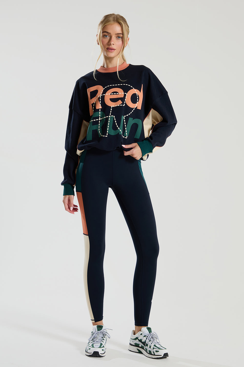 female model in a long sleeve crew neck navy red run sweater