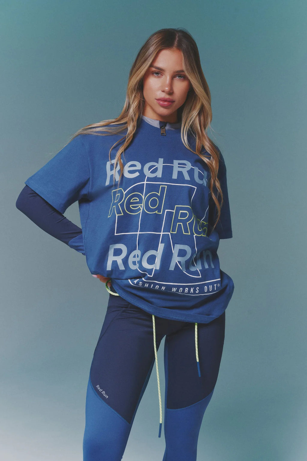 Woman wearing a blue athletic outfit with 'Red Run' branding on a solid background