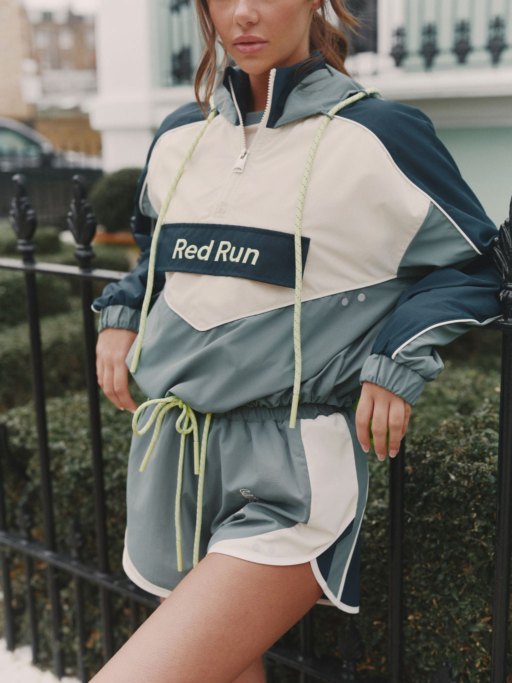 Person wearing a 'Red Run' tracksuit in an urban setting