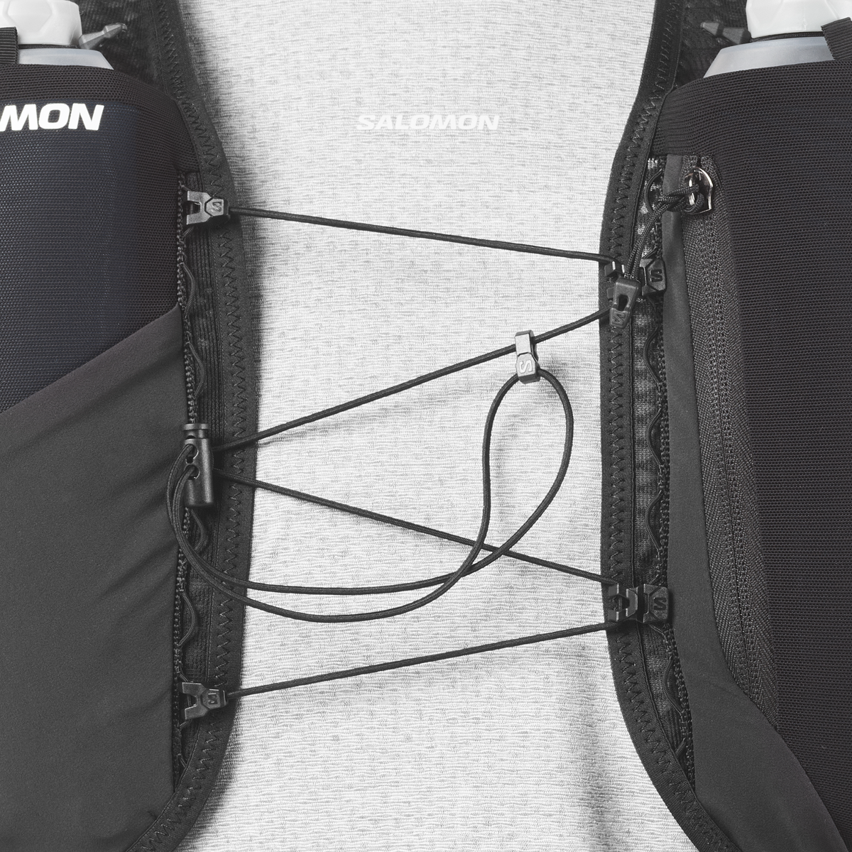 Close-up of a Salomon running backpack with hydration system on a light gray background