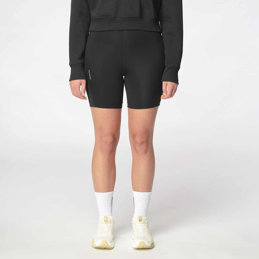 Person wearing black athletic shorts on a white background