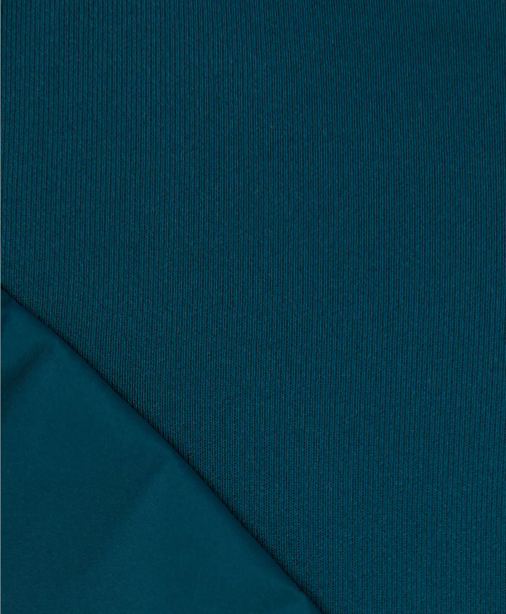 Teal fabric with a slight texture and fold
