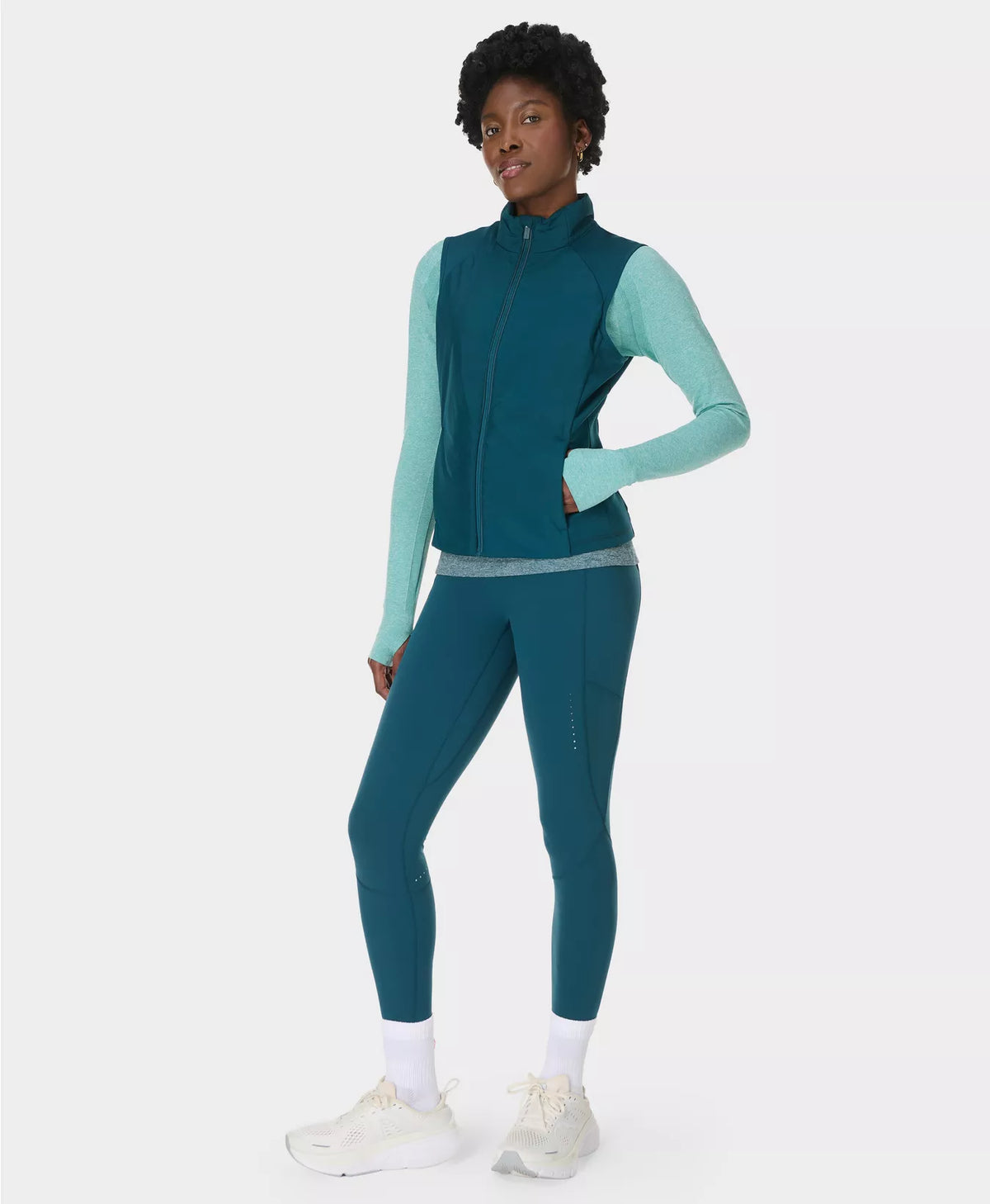 Person wearing a teal and light blue athletic outfit on a white background
