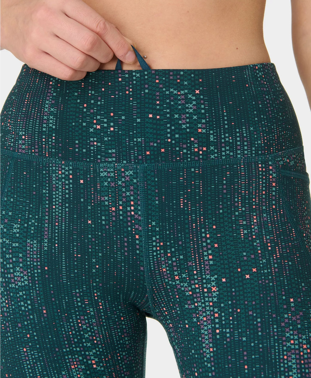 Teal leggings with a subtle pattern on a white background