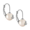 Cream pearl earrings by Vivienne Westwood, platinum plated. Subtle, classic jewelry for everyday wear.